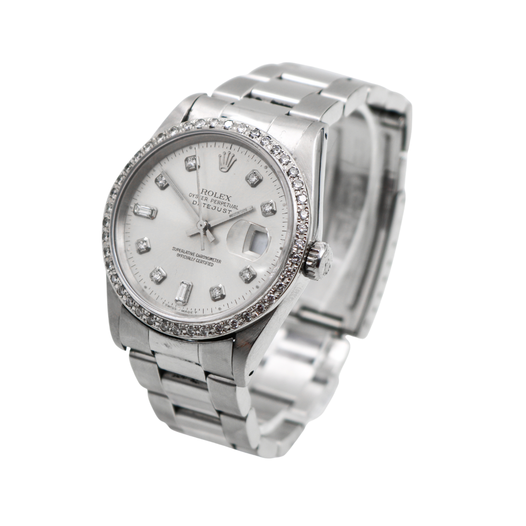 Silver Rolex Datejust watch angled left with diamond bezel and markers on silver dial.