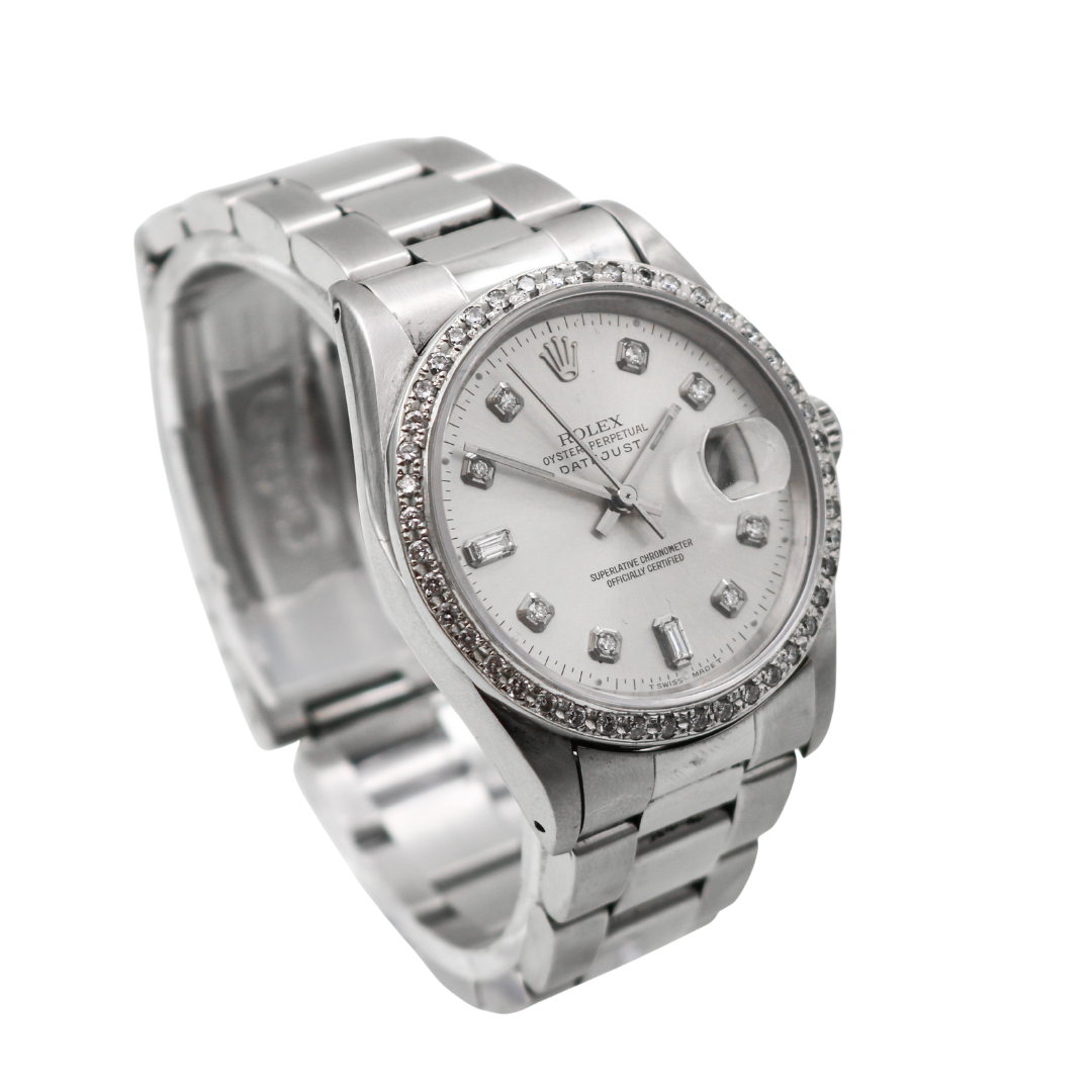 Diamond bezel Rolex Datejust watch angled right with silver dial and metal bracelet.