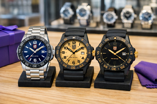 Three Luminox watches with black and blue dials displayed on stands in a retail store.