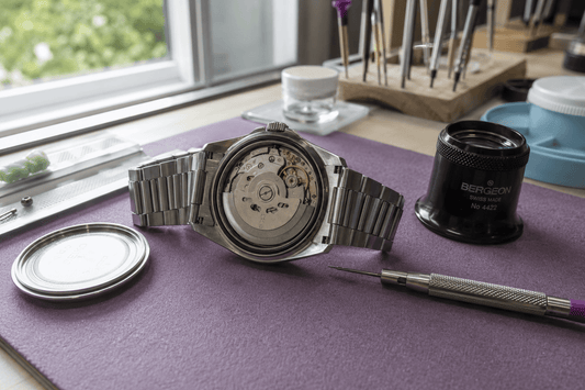 Automatic mechanical watch movement exposed during professional servicing