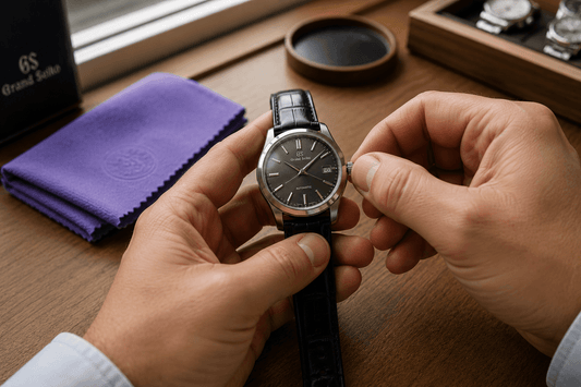 Watchmaker adjusting the crown of a luxury Grand Seiko watch during inspection.