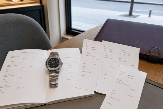 Luxury watch displayed with service records and maintenance documentation.