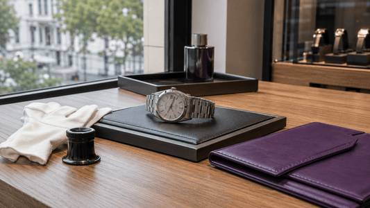 Stainless steel luxury watch prepared for final quality inspection on a presentation pad.