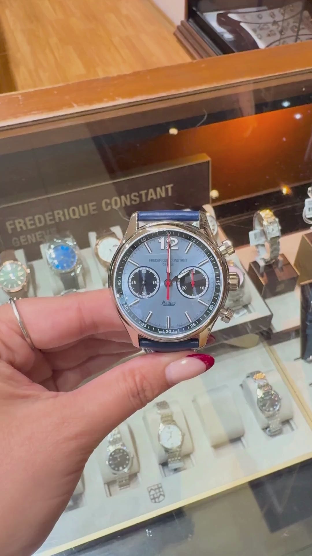 video of Frederique Constant Healey Chronograph 42 mm, showing its light blue dial, dual subdials, polished stainless steel case, blue leather strap with white stitching, and exhibition caseback.