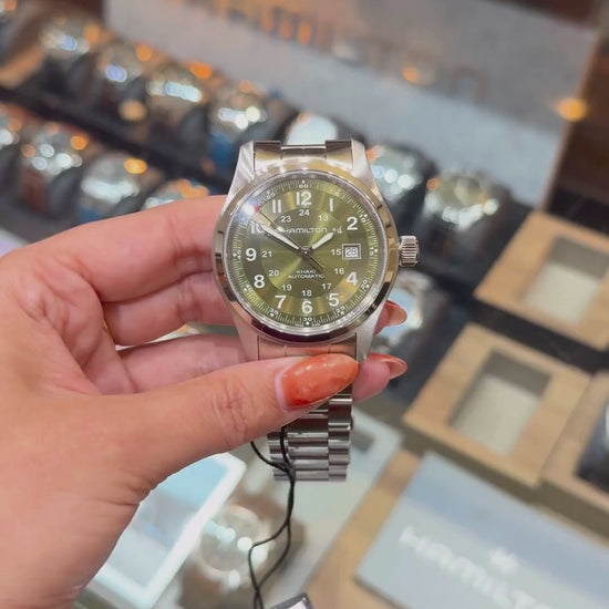 a video of Hamilton Khaki Field Automatic with green dial and date