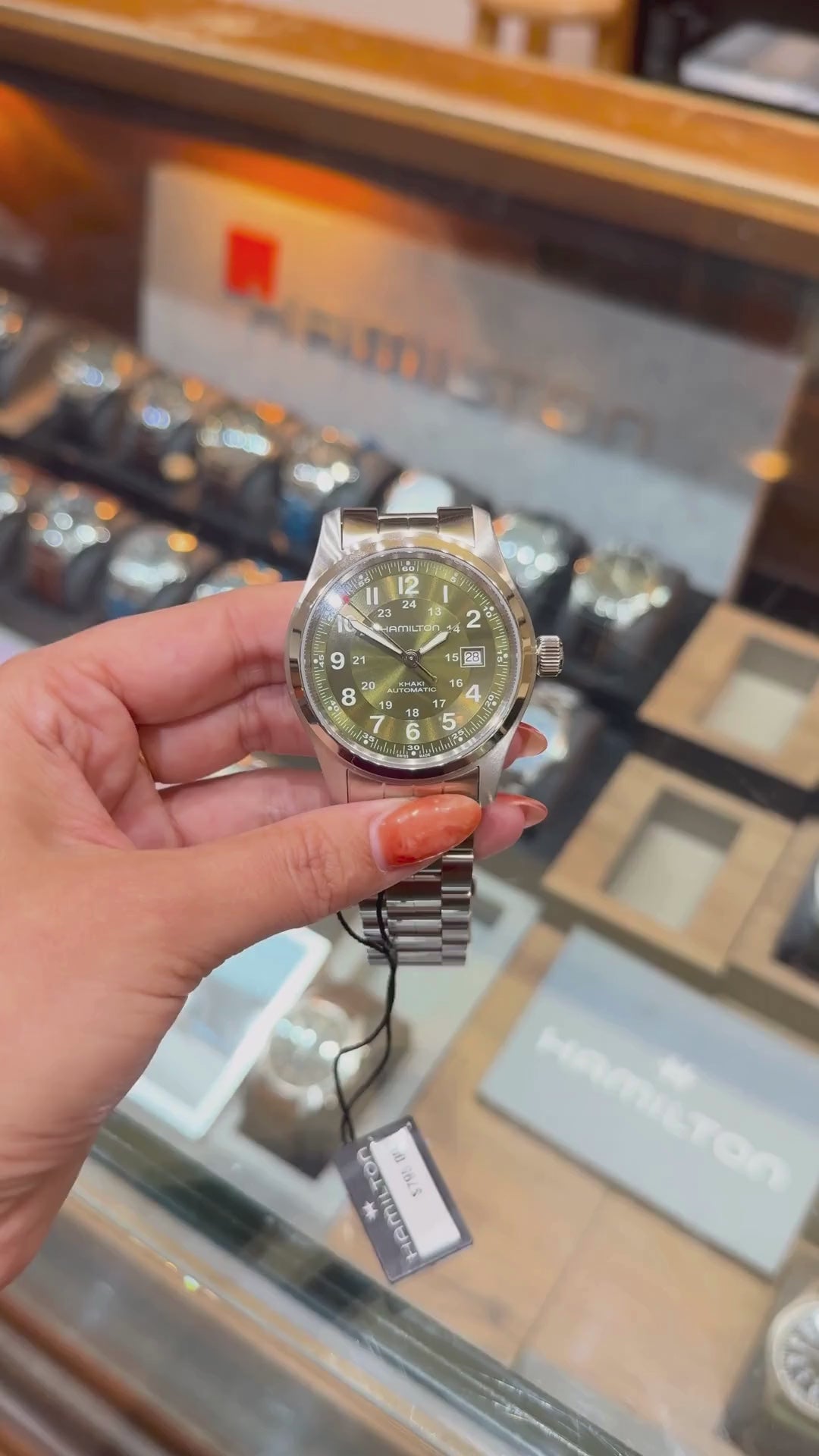 a video of Hamilton Khaki Field Automatic with green dial and date